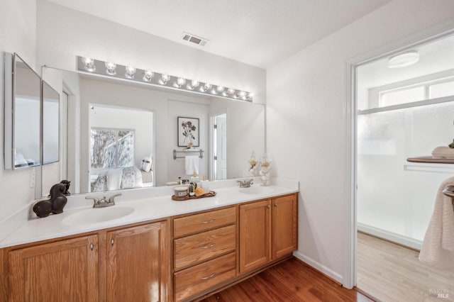 bathroom with vanity and wood-type flooring