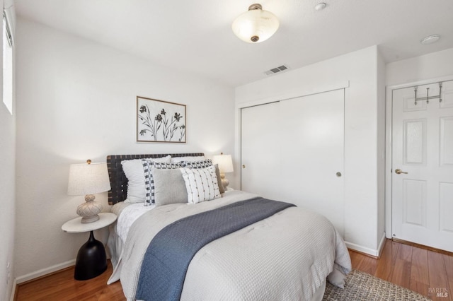 bedroom with hardwood / wood-style flooring and a closet