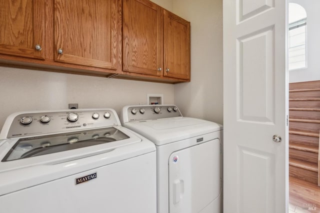 laundry area featuring cabinets and independent washer and dryer