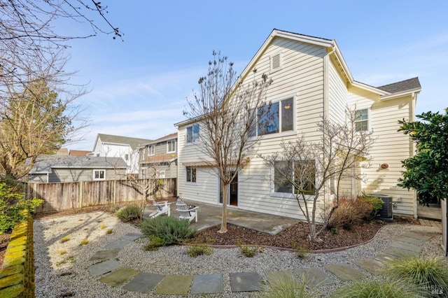 back of house with central AC unit and a patio