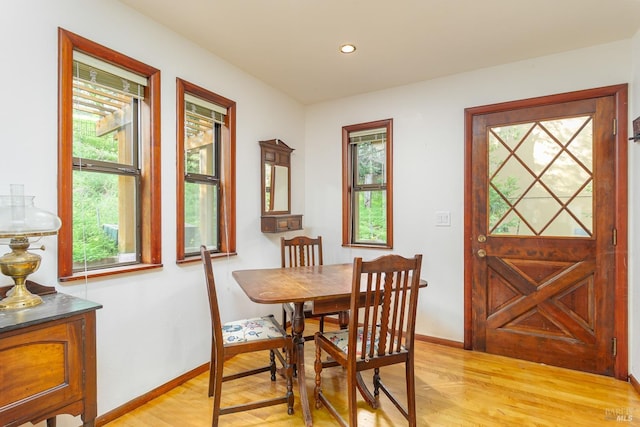 dining room with recessed lighting, light wood-type flooring, and baseboards