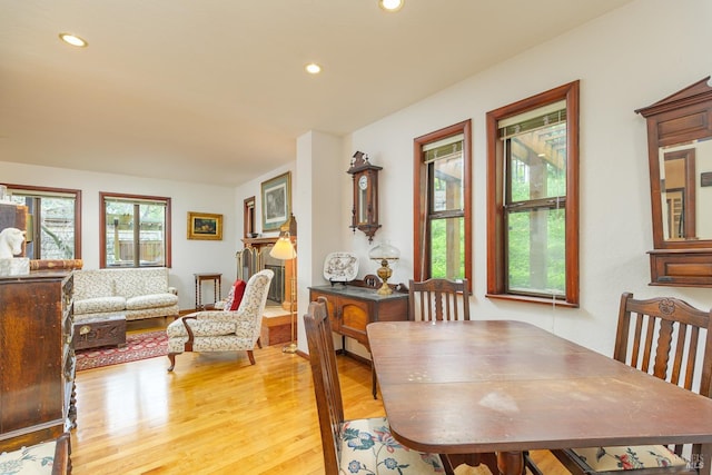 dining room with light wood-type flooring and recessed lighting