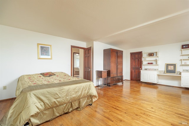 bedroom with light wood-style flooring and baseboards