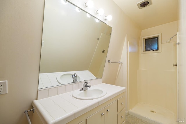 bathroom featuring a shower stall, visible vents, and vanity