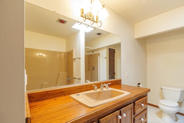 bathroom featuring toilet, baseboards, walk in shower, and vanity