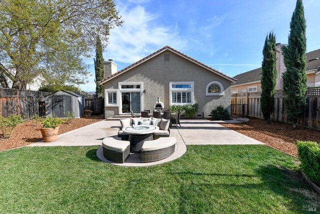 back of property with a patio area, outdoor lounge area, a storage unit, and a lawn