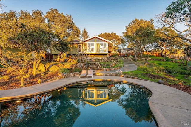 view of pool with a sunroom