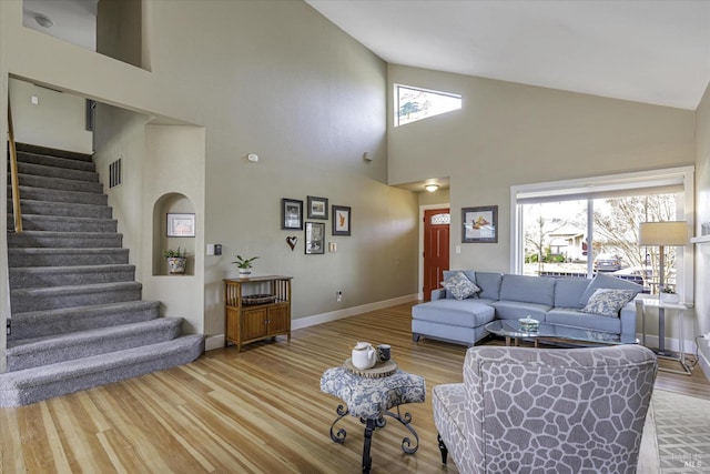 living room with hardwood / wood-style floors and high vaulted ceiling