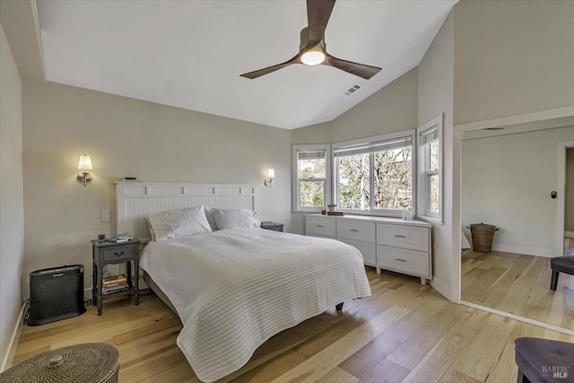 bedroom featuring high vaulted ceiling, ceiling fan, and light wood-type flooring