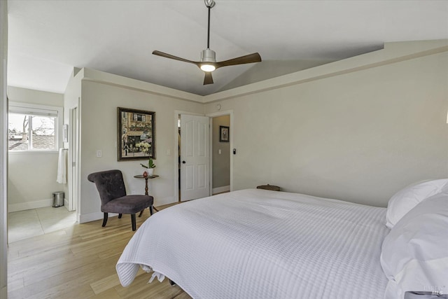 bedroom featuring ceiling fan, lofted ceiling, and light wood-type flooring