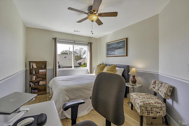 bedroom with ceiling fan and light hardwood / wood-style flooring