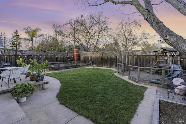 yard at dusk with a patio