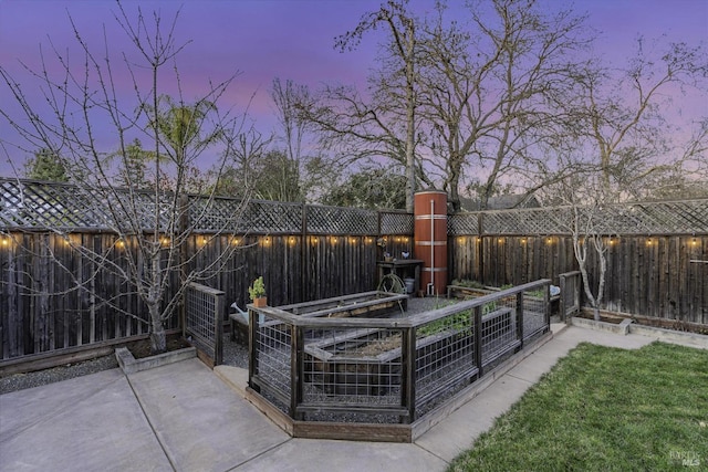 view of patio terrace at dusk