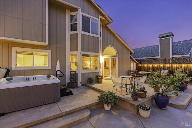 patio terrace at dusk with a hot tub