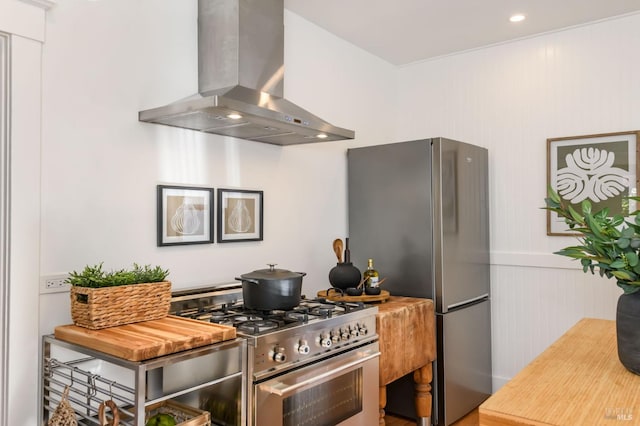 kitchen featuring stainless steel appliances, recessed lighting, and wall chimney exhaust hood