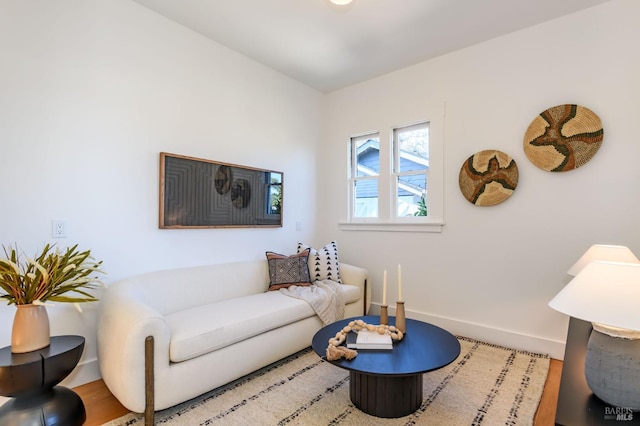 living room with baseboards and wood finished floors