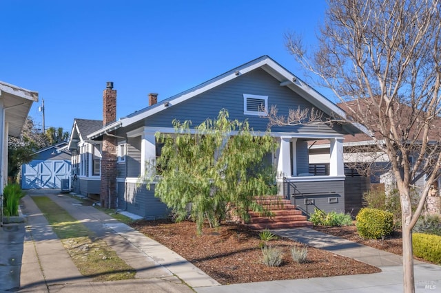 bungalow-style home with a porch and a chimney