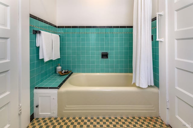 full bath featuring a bathing tub and tile walls