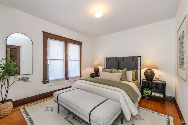 bedroom with wood finished floors and baseboards