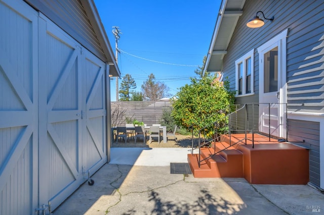 view of patio / terrace featuring fence and an outdoor structure