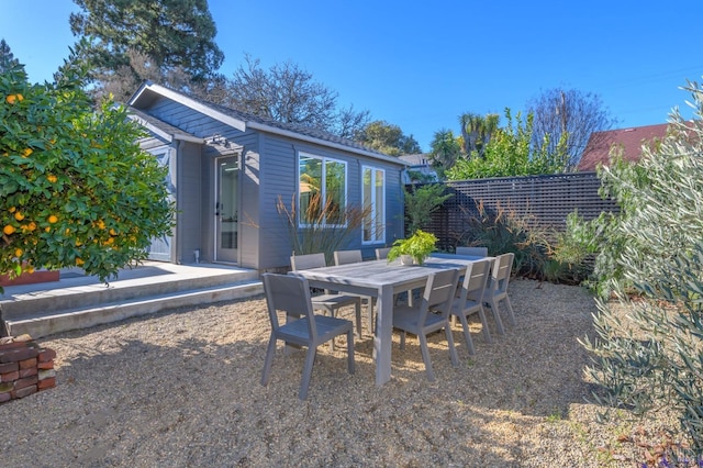 exterior space with fence and outdoor dining space