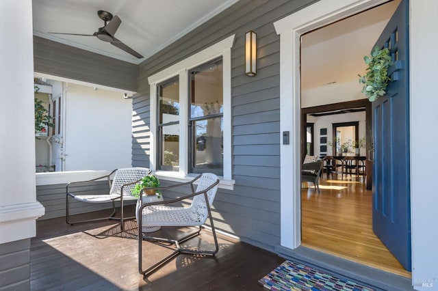 wooden terrace with a porch and a ceiling fan