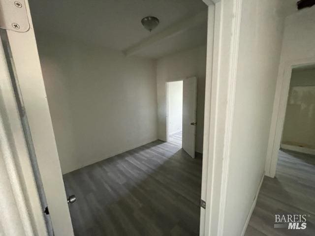 hallway with dark wood-type flooring