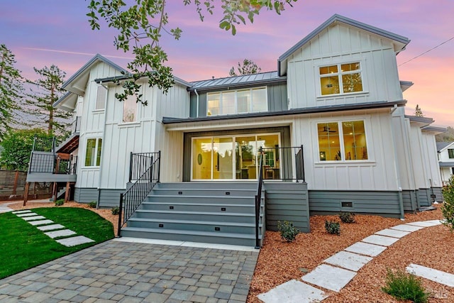 modern inspired farmhouse featuring board and batten siding, a standing seam roof, and metal roof