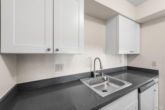 kitchen featuring dishwasher, white cabinetry, and sink