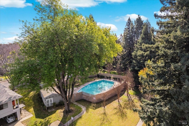 view of pool featuring a lawn