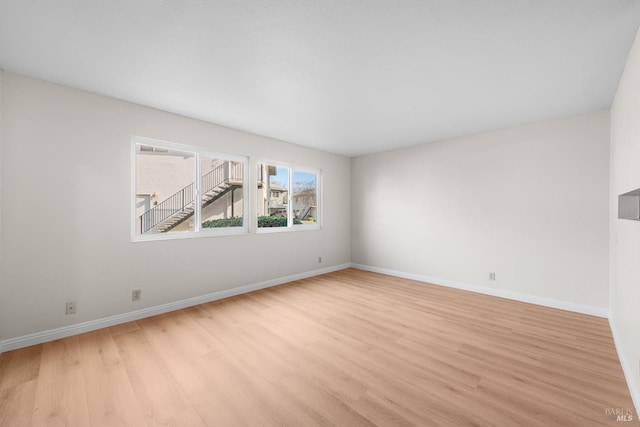 unfurnished room with light hardwood / wood-style floors