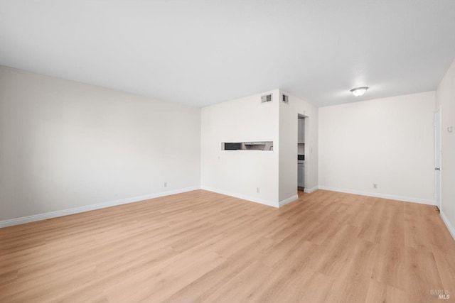 spare room with light hardwood / wood-style flooring