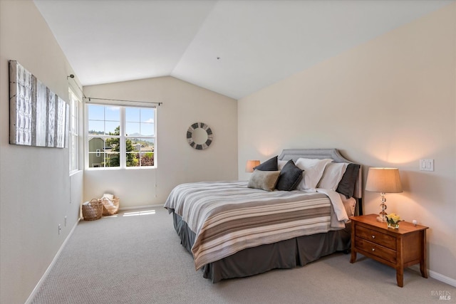 carpeted bedroom featuring lofted ceiling