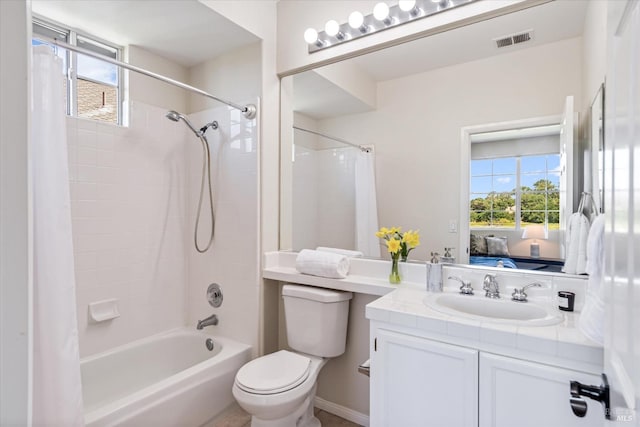 full bathroom featuring vanity, shower / bath combination with curtain, and toilet