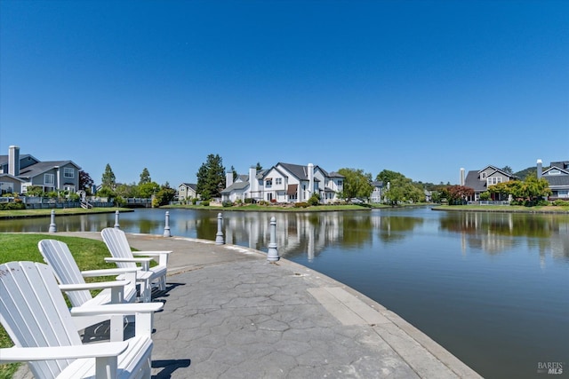 dock area featuring a water view and a patio