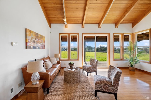 living room with lofted ceiling with beams, hardwood / wood-style floors, and wood ceiling