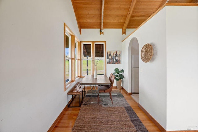 interior space featuring wood ceiling, lofted ceiling with beams, and light hardwood / wood-style flooring