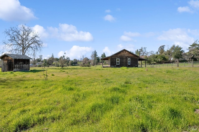 view of yard with a storage unit and a rural view