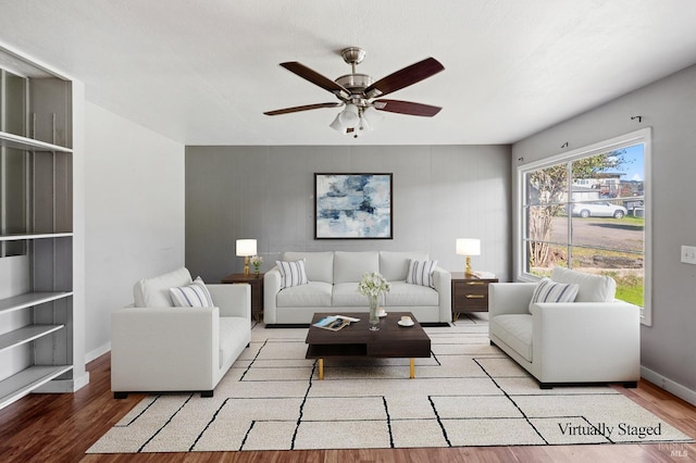 living room featuring ceiling fan and light hardwood / wood-style floors