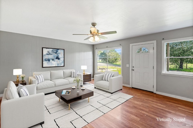 living room featuring ceiling fan and light wood-type flooring