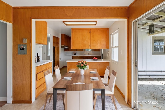 dining room with sink and wooden walls