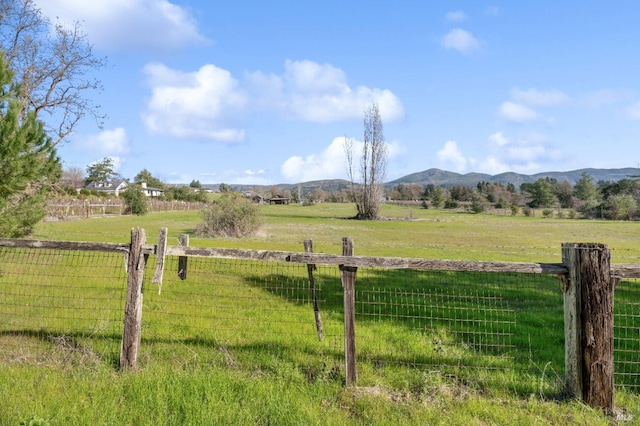 view of yard with a mountain view and a rural view