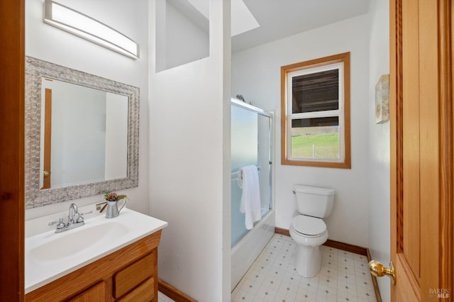 full bathroom with vanity, combined bath / shower with glass door, and toilet