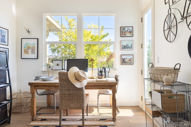 office area featuring light wood-type flooring and baseboards