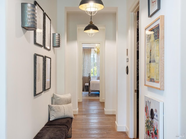 hallway featuring light wood-style floors and baseboards