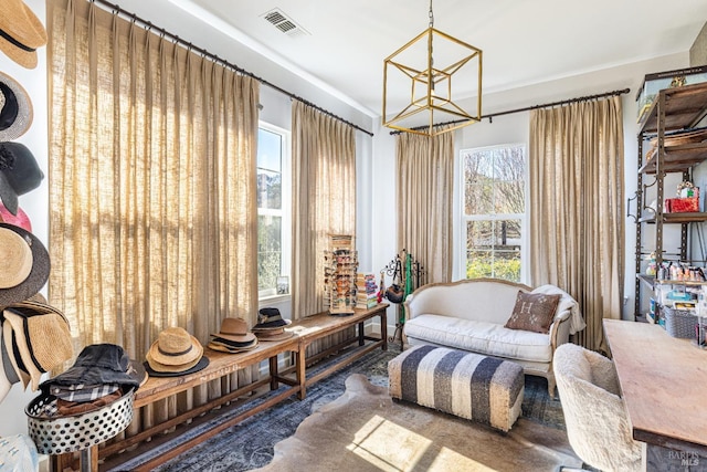 sitting room featuring visible vents and an inviting chandelier