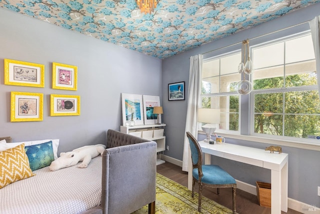 bedroom featuring wood finished floors and baseboards