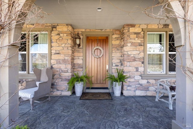 property entrance featuring stone siding