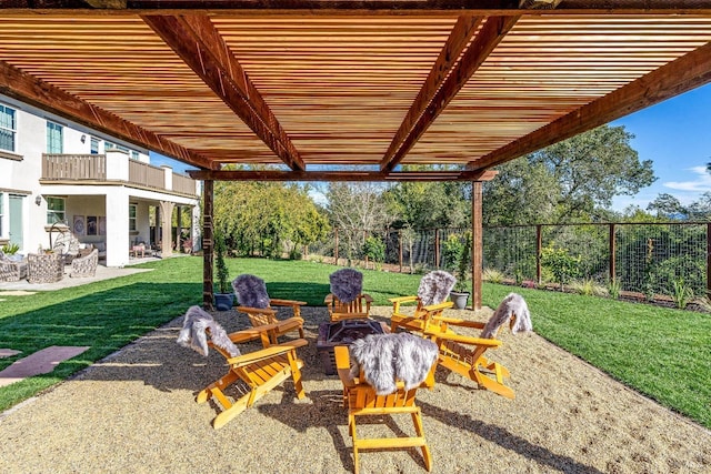 view of patio featuring fence and a balcony