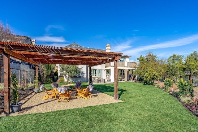 view of yard featuring an outdoor fire pit, fence, a balcony, and a pergola